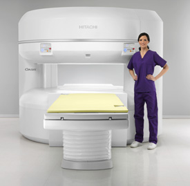 Open MRI machine with tech standing in front of